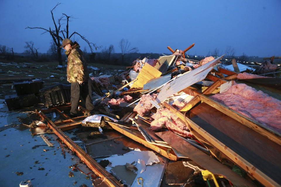 Carl Estes searches for books and other items from his church on County Road 911 that was completely destroyed by a tornado in Guntown, Miss., Monday, Dec. 16, 2019. (Thomas Wells/The Northeast Mississippi Daily Journal via AP)