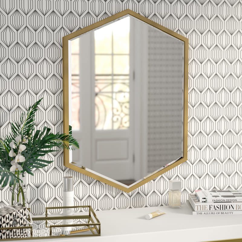 Get this minimalist one <a href="https://www.wayfair.com/Cherine-Hexagon-Wall-Mirror-WRLO8732.html" target="_blank">here, $146</a>.