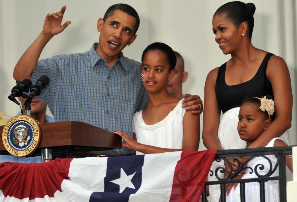 <p>Barack Obama chatted with Malia as Sasha and Michelle Obama looked on during their first Fourth of July celebration in the White House. </p>