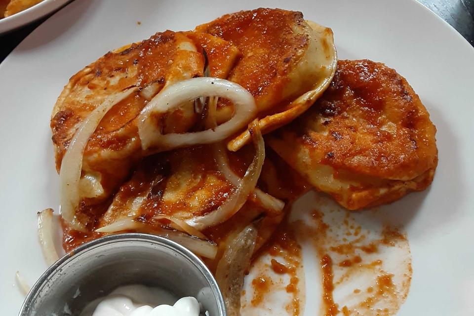 Pierogis doused in Buffalo sauce.