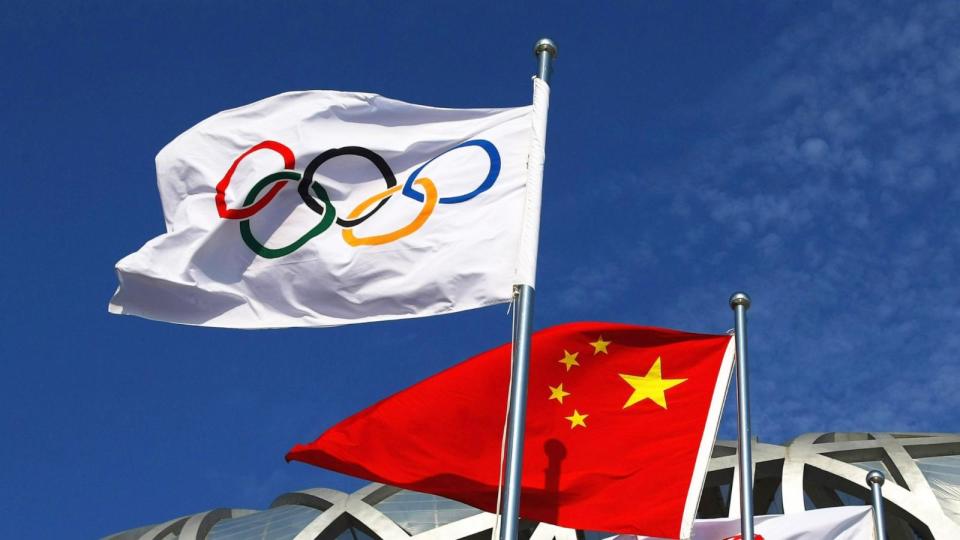 PHOTO: In this Aug. 5, 2008, file photo, the Olympic flag and the Chinese national flag fly outside the National Stadium in Beijing. (Clive Rose/Getty Images, FILE)