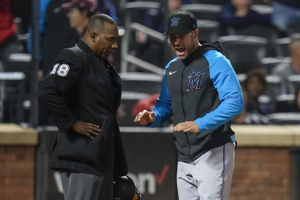 Miami Marlins manager Skip Schumaker, right, argues with home plate umpire Ramon DeJesus during the seventh inning in the second baseball game of a doubleheader against the New York Mets, Wednesday, Sept. 27, 2023, in New York. Schumaker was ejected from the game. (AP Photo/Frank Franklin II)