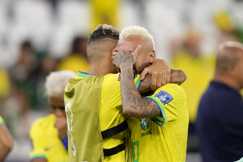 Brazil's Neymar is embraced by Brazil's Raphinha at the end of the World Cup quarterfinal soccer match between Croatia and Brazil, at the Education City Stadium in Al Rayyan, Qatar, Friday, Dec. 9, 2022. (AP Photo/Darko Bandic)