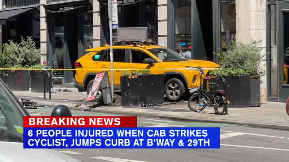 A taxi cab sits on the sidewalk in the Flatiron district after it jumped the curb and struck pedestrians (WABC-TV via AP)