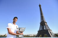 Serbia's Novak Djokovic poses with the trophy in front of the Eiffel tower during a photocall, Monday, June 14, 2021 in Paris, one day after winning French Open tennis tournament against Stefanos Tsitsipas of Greece. (Christophe Archanbault, Pool via AP)