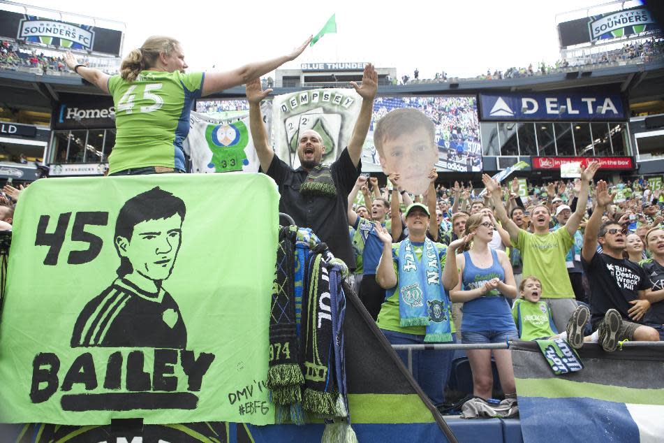 Seattle Sounders fans cheer for Seattle Sounders player Xander Bailey following a friendly soccer match against Tottenham Hotspur in Seattle, Saturday, July 19, 2014. The match ended in a 3-3 draw. Bailey was signed to the Sounders for the match as part of the Make-A-Wish program. (AP Photo/Stephen Brashear)