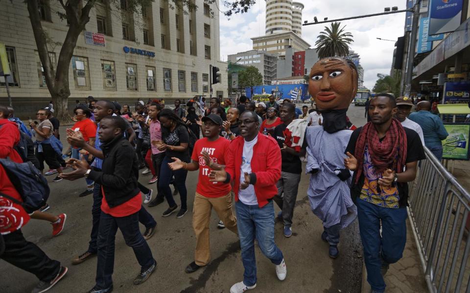 Protesters march against government corruption, on the 53rd anniversary of Kenya's independence, in downtown Nairobi, Kenya Monday, Dec. 12, 2016. Kenya's president on Monday criticized the International Criminal Court as "not impartial," saying his government "will give serious thought" to its membership of the court. (AP Photo/Ben Curtis)