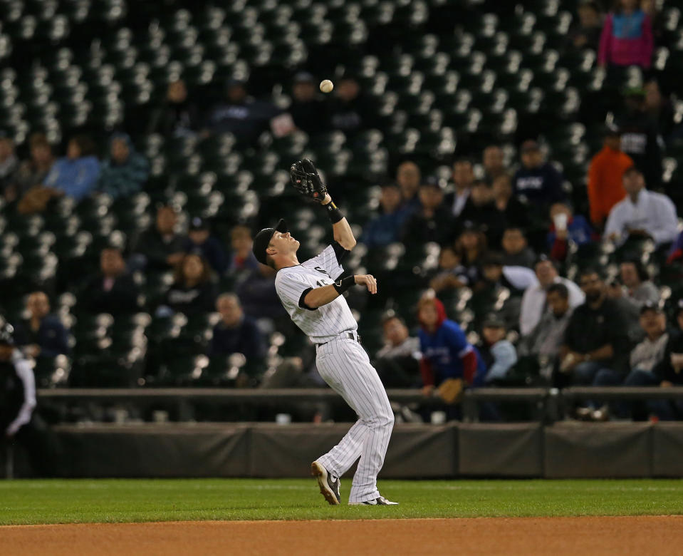 Gordon Beckham #15 of the Chicago White Sox makes a catch in front of fans and empty seats against the Toronto Blue Jays at U.S. Cellular Field on September 23, 2013 in Chicago, Illinois. The White Sox defeated the Blue Jays 3-2. (Photo by Jonathan Daniel/Getty Images)