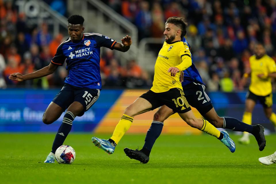 Dec 2, 2023; Cincinnati, Ohio, USA; Columbus Crew forward Diego Rossi (10) races to the ball with FC Cincinnati defender Alvas Powell (2) and defender Yerson Mosquera (15) during the second half of the MLS Cup Eastern Conference Finals at TQL Stadium.