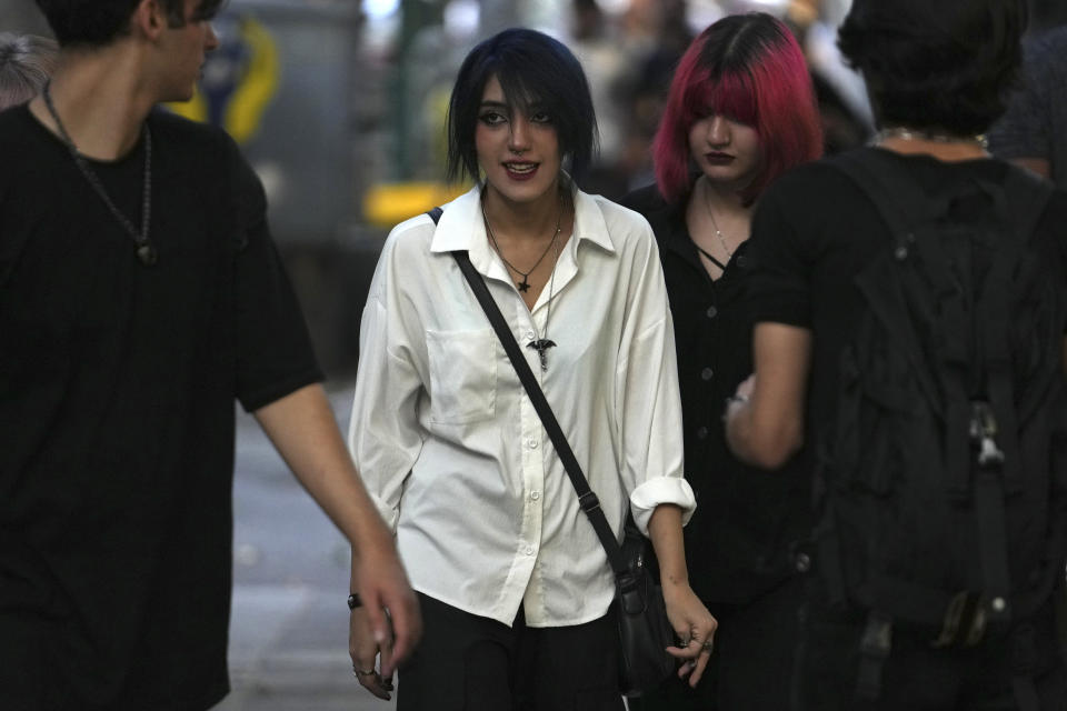 Iranian women walk in Tehran, Iran, Saturday, Aug. 5, 2023. These days, with uncovered women a common sight on Tehran streets, authorities have begun raiding companies where women employees or customers have been seen without the headscarf, or hijab. Iran's parliament is discussing a law that would increase punishments on uncovered women and the businesses they frequent. (AP Photo/Vahid Salemi)