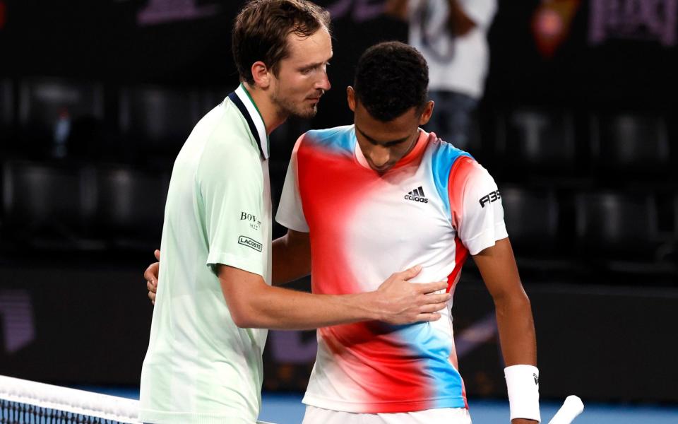  Daniil Medvedev, left, of Russia is congratulated by Felix Auger-Aliassime of Canada after winning their quarterfinal match at the Australian Open - AP