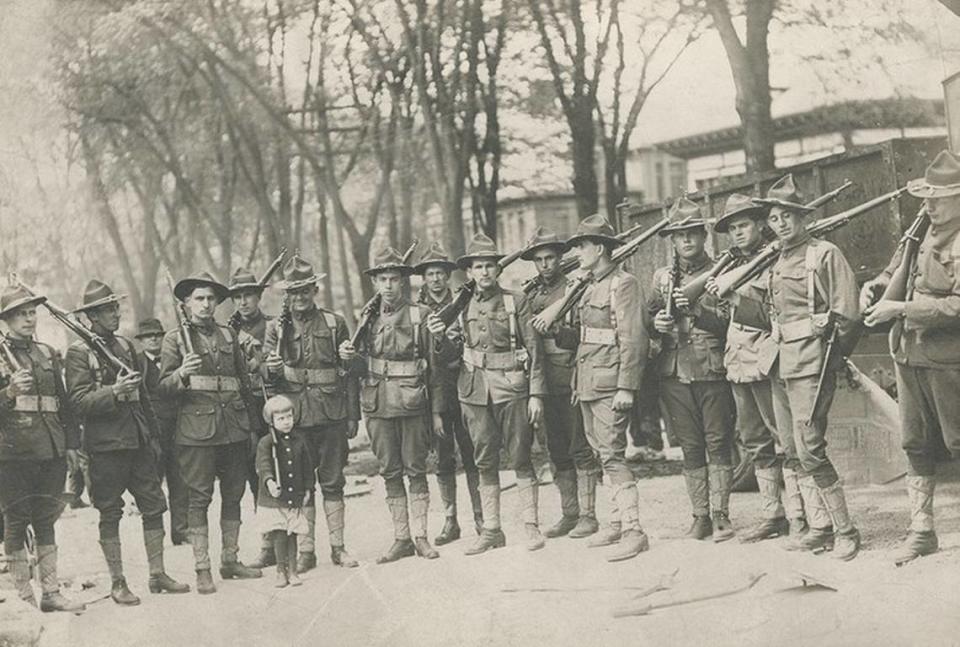 Among the exhibits in “The Little War” at the National WWI Museum and Memorial is a photograph of a young girl holding a toy rifle as she poses with American soldiers. National WWI Museum and Memorial