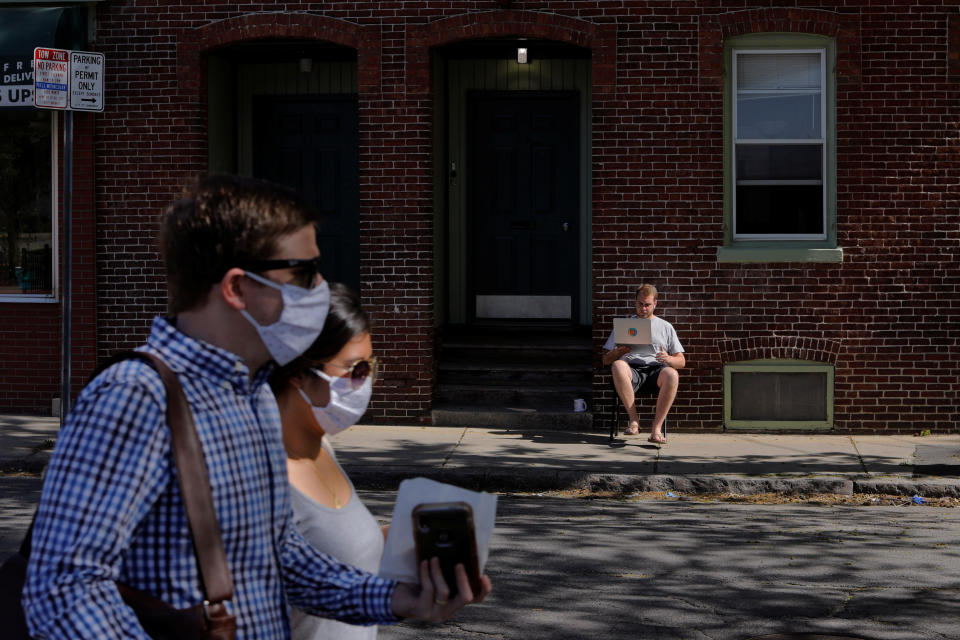 Jack Coopersmith sits outside his apartment and takes part in remote meeting while working from home amid the coronavirus disease (COVID-19) outbreak in Cambridge, Massachusetts, U.S., May 22, 2020.   REUTERS/Brian Snyder