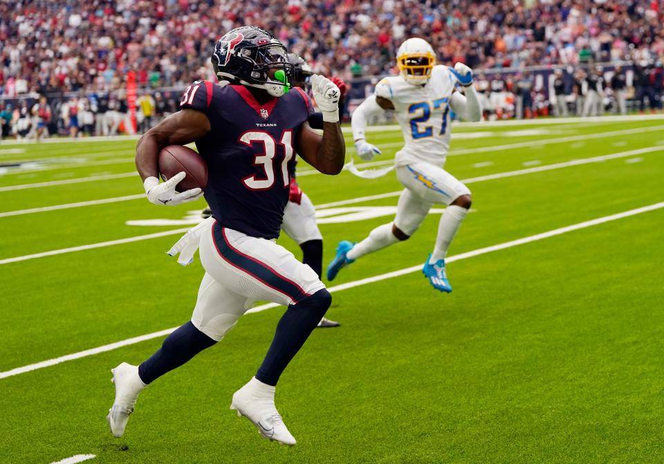 Houston Texans running back Dameon Pierce (31) runs for a touchdown against the Los Angeles Chargers during the first half of an NFL football game Sunday, Oct. 2, 2022, in Houston. (AP Photo/David J. Phillip)