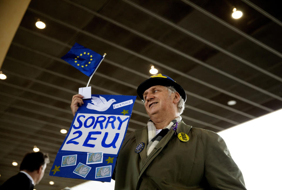 A pro-EU protestor holds a sign in front of EU headquarters in Brussels, Wednesday, Oct. 16, 2019. European Union and British negotiators have failed to get a breakthrough in the Brexit talks during a frantic all-night session and will continue seeking a compromise on the eve of Thursday's crucial EU summit. (AP Photo/Virginia Mayo)