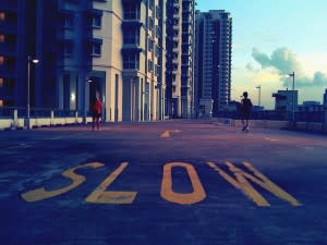 SLOW sign in front of flats