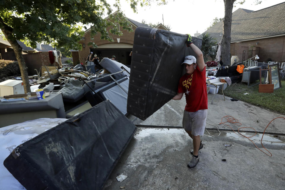 <p>Tyler Moody removes a mattress from a friend’s home after floodwaters from Tropical Storm Harvey drenched the city Thursday, Aug. 31, 2017, in Houston. (Photo: Gregory Bull/AP) </p>