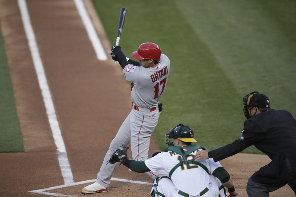 Los Angeles Angels' Shohei Ohtani singles against the Oakland Athletics during the first inning of a baseball game in Oakland, Calif., Friday, July 24, 2020. (AP Photo/Jeff Chiu)