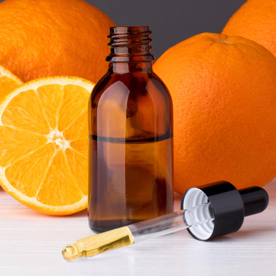 Orange essential oil and oranges