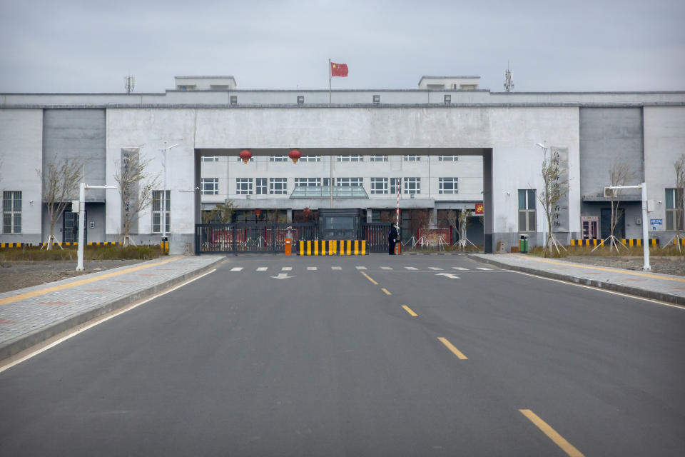 FILE - Police officers stand at the outer entrance of the Urumqi No. 3 Detention Center in Dabancheng in western China's Xinjiang Uyghur Autonomous Region on April 23, 2021. Urumqi No. 3, China's largest detention center, is twice the size of Vatican City and has room for at least 10,000 inmates.The U.S. Holocaust Memorial Museum says it has compiled evidence of increasing government repression against Uyghur Muslims in China's western Xinjiang region (AP Photo/Mark Schiefelbein, File)