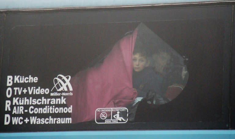 A Syrian boy onboard a bus from government-held Fuaa and Kafraya arrives in rebel-held Rashidin as part of an evacuation deal on April 14, 2017