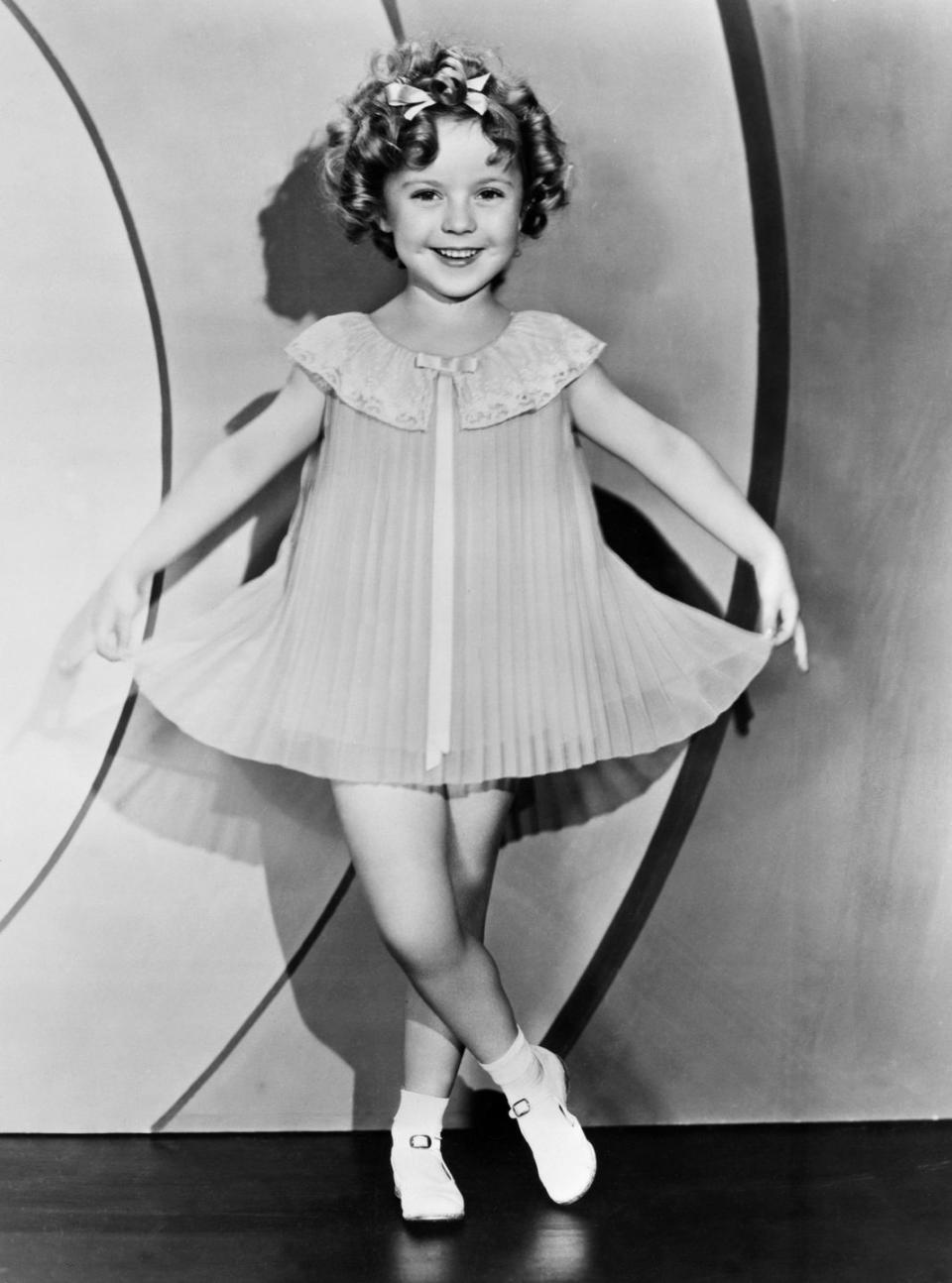 <p>While the country was in the depths of the Great Depression, President Roosevelt referred to the child star as <a href="https://www.cnn.com/2014/02/11/showbiz/movies/shirley-temple-child-star-appreciation/index.html" rel="nofollow noopener" target="_blank" data-ylk="slk:Little Miss Miracle;elm:context_link;itc:0;sec:content-canvas" class="link ">Little Miss Miracle</a> and credited her with boosting the country's morale. By 1935, Shirley was the biggest film star in America. That year she released some of her most beloved films, including <em>Curly Top </em>to <em>The Littlest Rebel</em>, and worked with some of the biggest names in the business.<br></p>