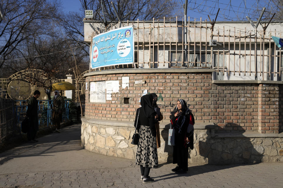 Afghan women students stand outside the Kabul University in Kabul, Afghanistan, Wednesday, Dec. 21, 2022. Taliban security forces in Afghanistan's capital city are upholding a higher education ban for women by blocking access to university campuses. The country's Taliban rulers have ordered women nationwide to stop attending private and public universities effective immediately and until further notice. The Taliban-led administration has not given a reason for the ban or reacted to the fierce and swift global condemnation of it.(AP Photo/Ebrahim Noroozi)