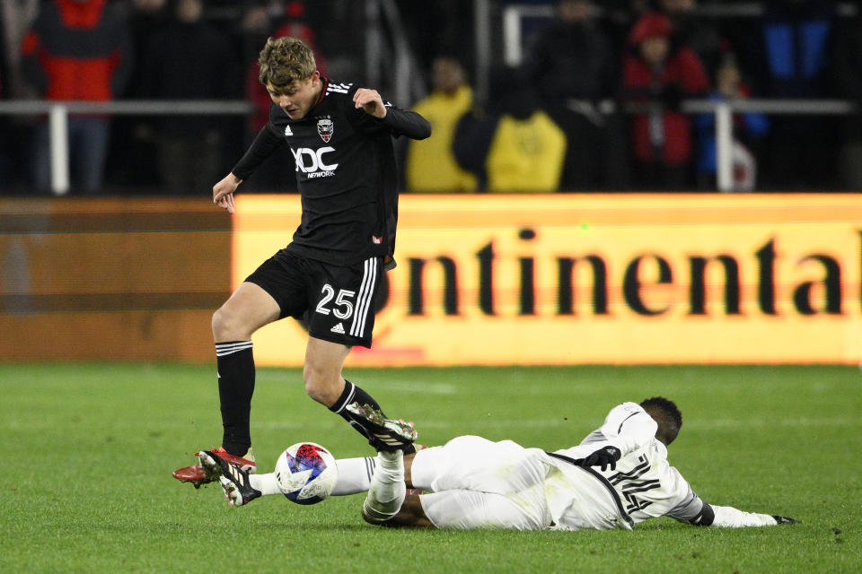 D.C. United midfielder Jackson Hopkins (25) battles Toronto FC midfielder Mark-Anthony Kaye (14) for the ball during the second half of an MLS soccer match, Saturday, Feb. 25, 2023, in Washington. (AP Photo/Nick Wass)