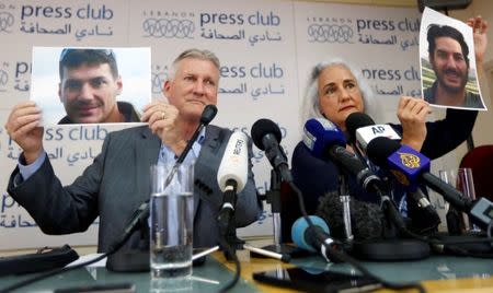 Debra Tice, the mother of American journalist Austin Tice, holds his picture with her husband Marc Tice during a news conference in Beirut, Lebanon July 20, 2017. REUTERS/Jamal Saidi