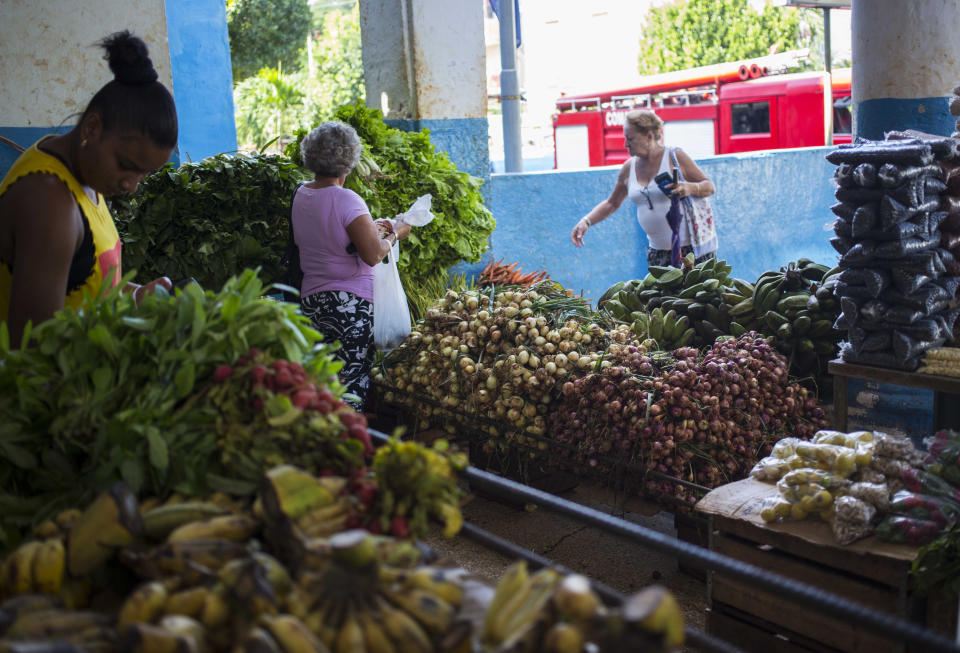 People buy local vegetables at a food shop in Havana, Cuba, Thursday, Nov. 8, 2018. Entrepreneurs from the United States’ agricultural sector have arrived in Cuba to promote business between the two countries. (AP Photo/Desmond Boylan)