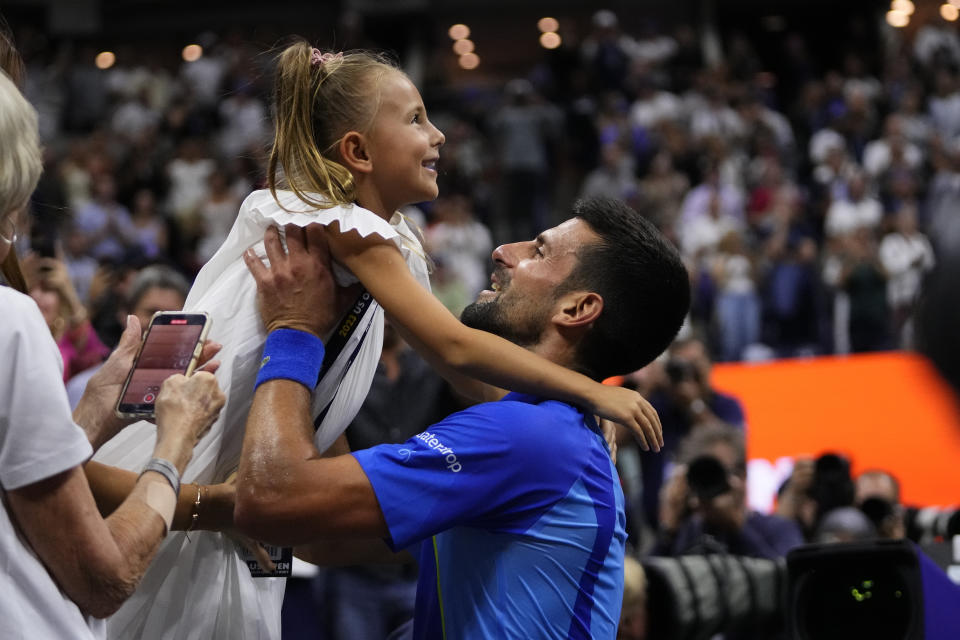 Novak Djokovic, of Serbia, holds up his daughter Tara after defeating Daniil Medvedev, of Russia, in the men's singles final of the U.S. Open tennis championships, Sunday, Sept. 10, 2023, in New York. (AP Photo/Frank Franklin II)