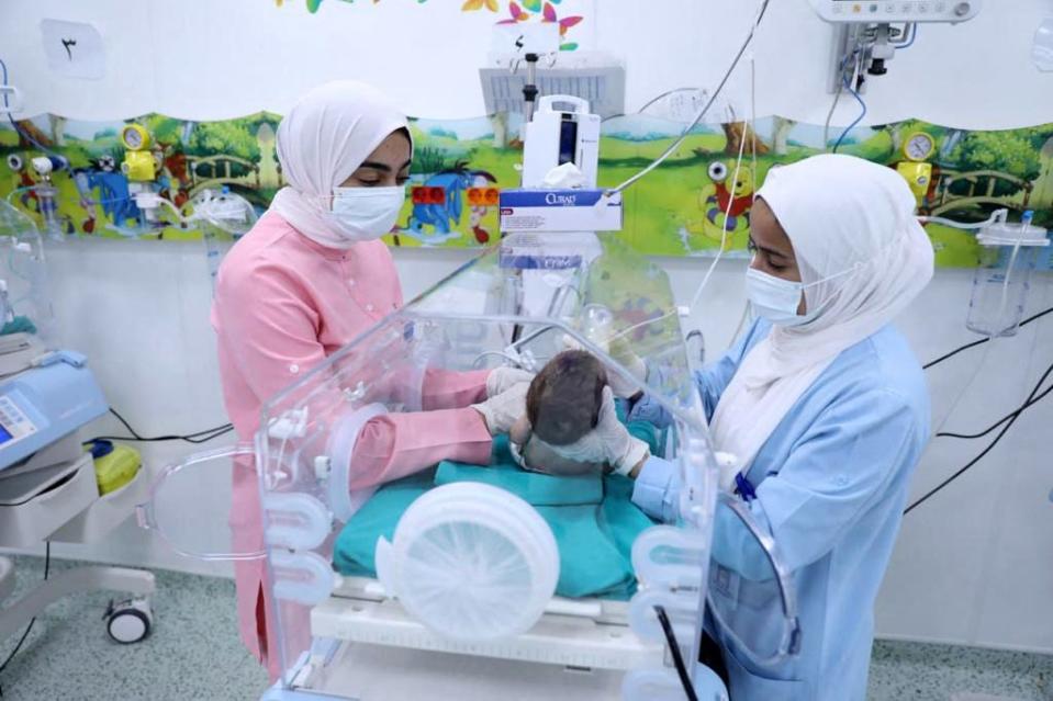 A handout picture provided by the Egyptian health Ministry on November 20, 2023, shows medics caring for premature Palestinian babies evacuated from Gaza at a hospital in Cairo's New Administrative Capital.