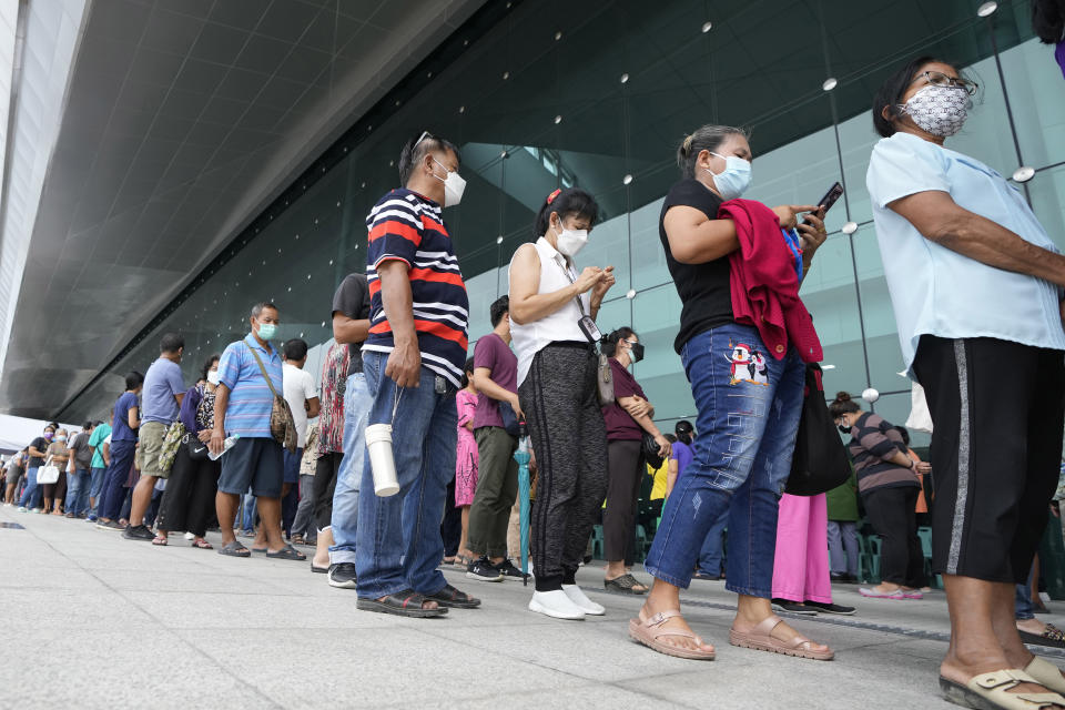 Residents wait on line to receive shots of the AstraZeneca COVID-19 vaccine at the Central Vaccination Center in Bangkok, Thailand, Thursday, July 22, 2021. (AP Photo/Sakchai Lalit)