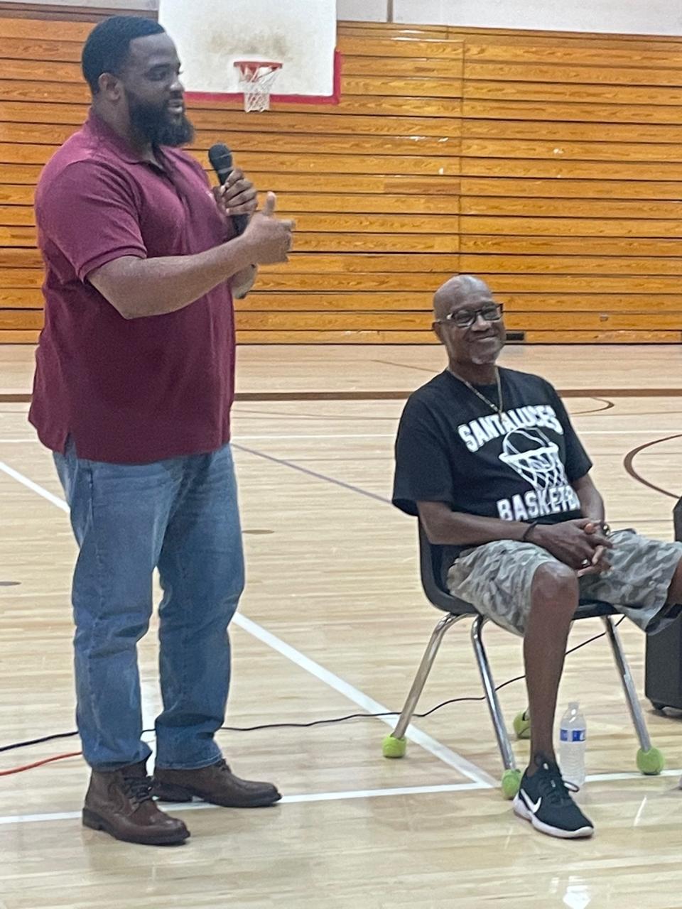 Former Santaluces player Terrence Atkinson, now the head coach at Park Vista, helps surprise longtime head coach Willie Gibson during a court-naming ceremony at the Lantana school on Sunday, Nov. 13, 2022.