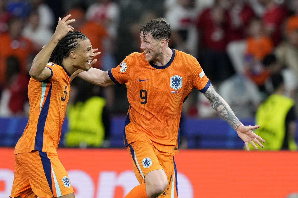 Wout Weghorst of the Netherlands, right, and Nathan Ake of the Netherlands celebrate after a quarterfinal match between the Netherlands and Turkey at the Euro 2024 soccer tournament in Berlin, Germany, Saturday, July 6, 2024. (AP Photo/Antonio Calanni)