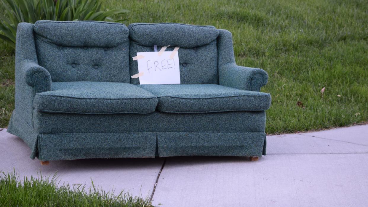 A free couch on a sidewalk