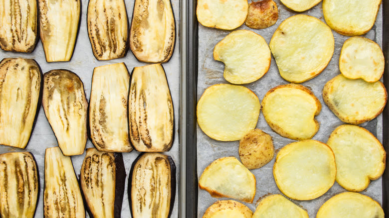 Baked eggplant and potato slices on baking sheets