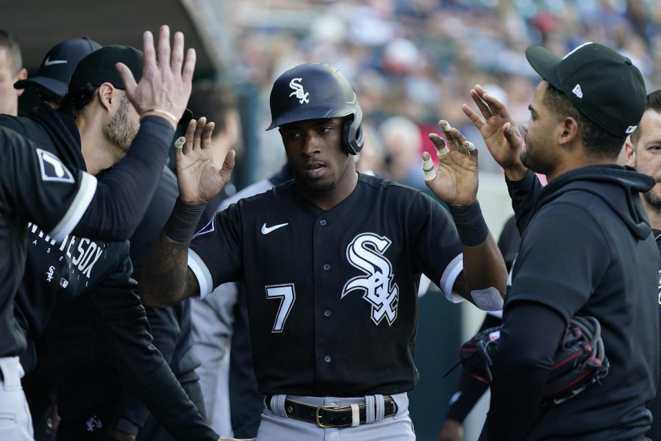 Chicago White Sox's Tim Anderson is greeted in the dugout after scoring from first on a triple by Andrew Benintendi during the second inning of a baseball game against the Detroit Tigers, Friday, May 26, 2023, in Detroit. (AP Photo/Carlos Osorio)