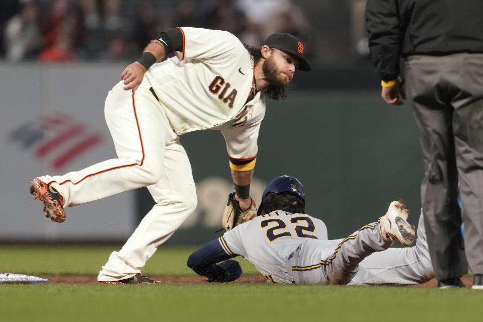 Milwaukee Brewers' Christian Yelich (22) is tagged out by San Francisco Giants shortstop Brandon Crawford on at attempted steal during the third inning of a baseball game in San Francisco, Wednesday, Sept. 1, 2021. (AP Photo/Jeff Chiu)