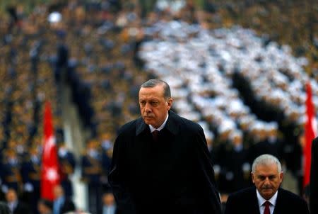 Turkey's President Tayyip Erdogan attends a Republic Day ceremony at Anitkabir, the mausoleum of modern Turkey's founder Ataturk, to mark the republic's anniversary as he is flanked by Prime Minister Binali Yildirim (R) in Ankara, Turkey, October 29, 2016. REUTERS/Umit Bektas