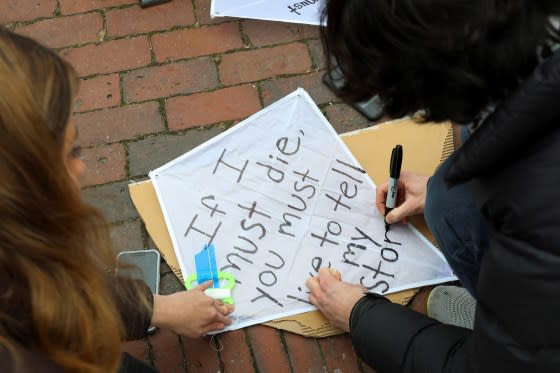 Demonstrators decorate a kite with a quote from Palestinian poet Refaat Alareer at a rally held by the Boston Coalition for Palestine calling for a permanent ceasefire in Gaza, in Boston, Mass., Dec. 17.<span class="copyright">Reba Saldanha—Reuters</span>