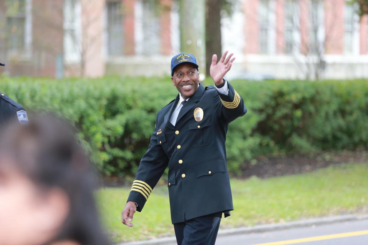 Savannah Police Chief Roy Minter waves as he walks along Oglethorpe Avenue on Thursday during the annual Savannah Veterans Day Parade.