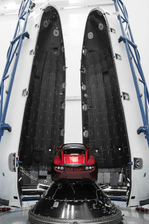 A red Tesla Roadster is seen during preparations to use it as a mock payload for the launch of a SpaceX Falcon Heavy rocket, in Cape Canaveral, Florida, U.S. December 6, 2017. Picture taken December 6, 2017. Flickr.com/photos/SpaceX via REUTERS