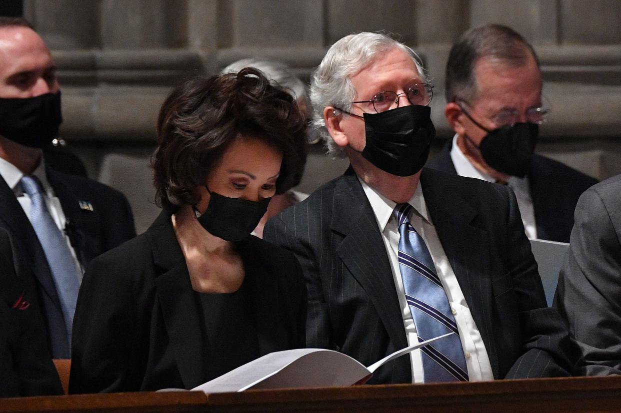 Senate Minority Leader Mitch McConnell sits with his wife former Secretary of Transportation Elaine Chao, during the funeral of former Senator John Warner at the National Cathedral in Washington, DC on June 23, 2021.