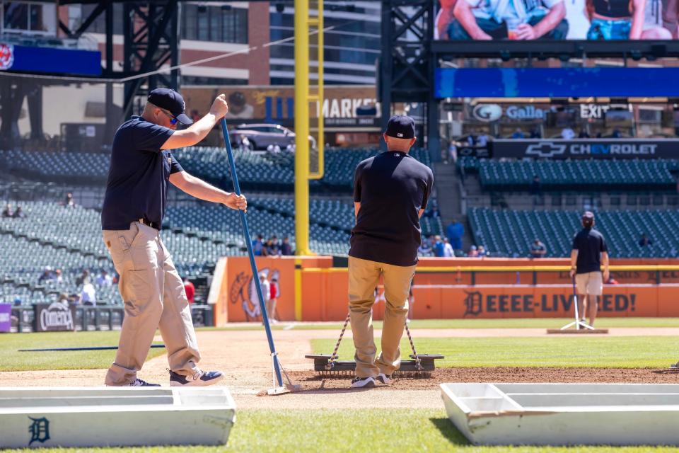 Workers get the baseball diamond ready for the game between the Detroit Tigers and the Kansas City Royals at Comerica Park in Detroit on Friday, April 26, 2024.