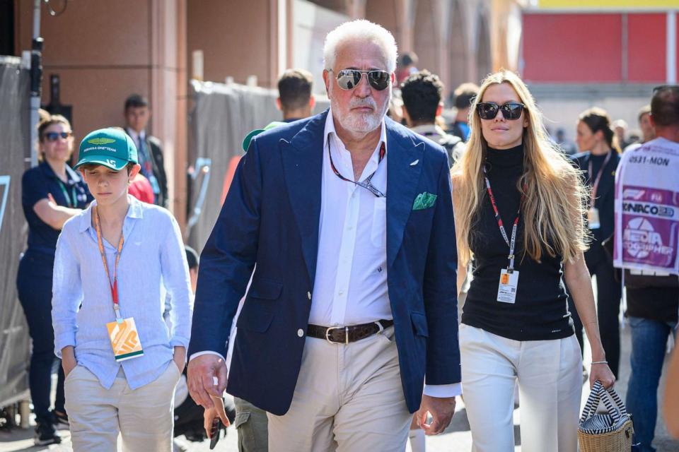 PHOTO: Executive Chairman of Aston Martin Lawrence Stroll and his wife Raquel walk through the F1 paddock at the Monaco F1 Grand Prix in Monaco, May 27, 2023. (Jure Makovec/SOPA Images via Getty Images)