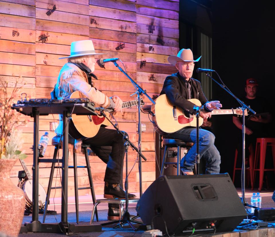 Lyle Lovett (right) speaks about Michael Martin Murphey Sunday evening at the Rangeland Fire Relief Benefit Concert at the Starlight Ranch in Amarillo.