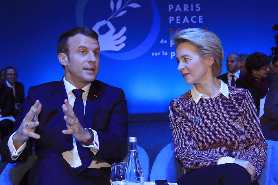 European Commission president Ursula von der Leyen listens to French President Emmanuel Macron at the start of the Paris Peace Forum Tuesday, Nov. 12, 2019 in Paris. (AP Photo/Michel Euler, Pool)