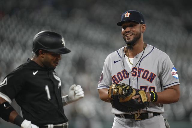 Houston Astros first baseman Jose Abreu, right, smiles as his former teammate, Chicago White Sox's Elvis Andrus, left, is out at first base during the third inning of a baseball game Friday, May 12, 2023, in Chicago. (AP Photo/Erin Hooley)