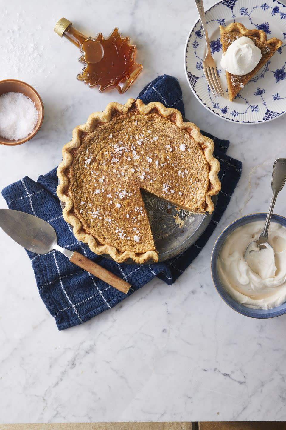 salted maple syrup pie with a slice cut out an on a plate to the side with a fork